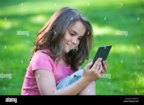 Young Girl Reading With E Reader Stock Photo Alamy