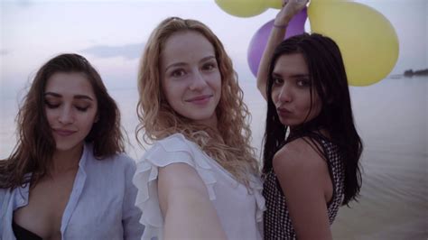 Mixed Race Friends Making Selfie Three Beautiful Young Women Making Selfie At Sunset On A Beach