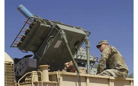 A Us Soldier Attends To An M139 Volcano Mine Dispenser Fitted With