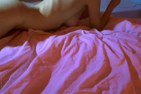 Naked In Pink Bed With Copyspace By Stocksy Contributor Sonja