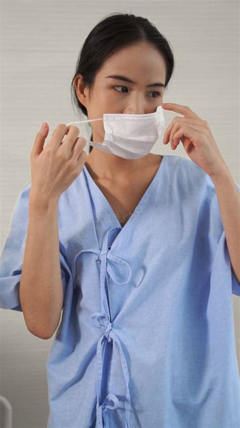 Young Asian Woman Take Off Face Mask Removing From Face Stock Image