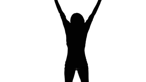 Silhouette Of A Woman Jumping And Raising Her Arms On White Background In Slow Motion Stock