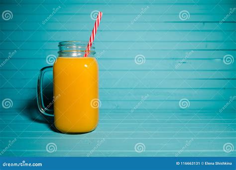 Freshly Squeezed Orange Juice In A Jar With A Reusable Tubule On A