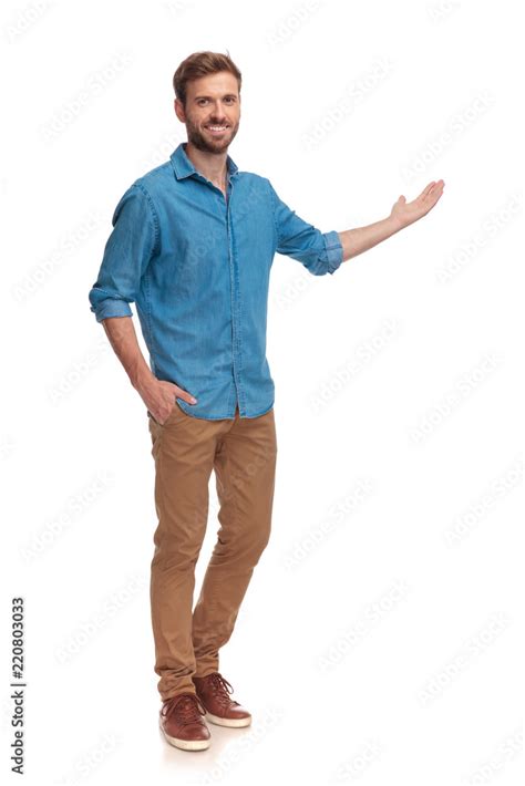 Full Body Picture Of A Young Casual Man Presenting Stock Photo Adobe
