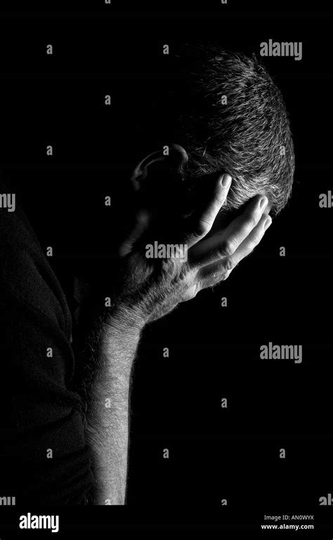 A Profile Shot Of A Dejected Man Head In Hands Stock Photo Alamy