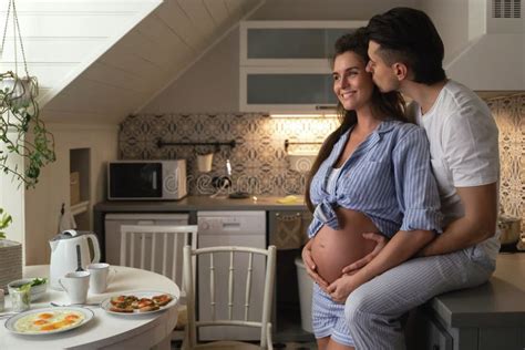 Husband And His Pregnant Wife On The Kitchen During Breakfast Time Stock Image Image Of