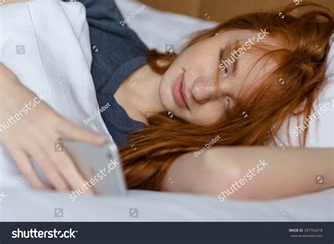 Portrait Of A Beautiful Redhead Woman Sleeping In The Bed At Home Stock