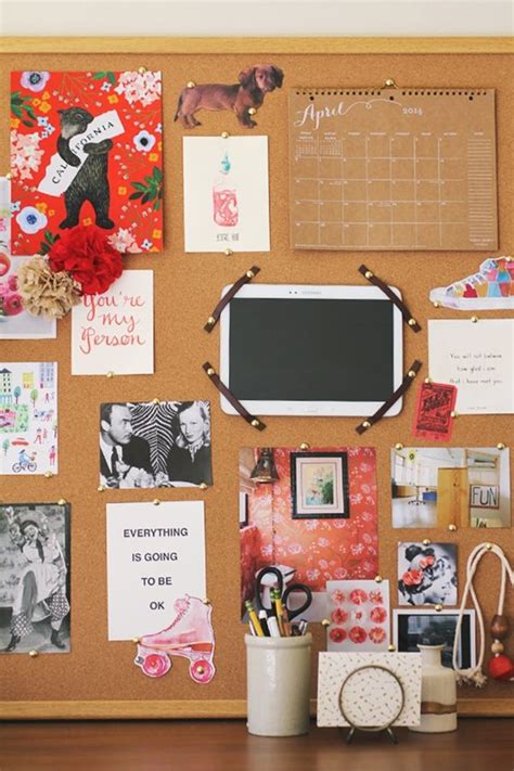 A Cork Board With Pictures And Magnets On It Next To A Cup Filled With
