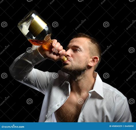 Man Drinking Cognac Alcohol Whiskey From The Bottle Stock Photo Image