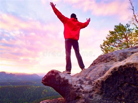 Hiker Standing On Top Of A Mountain And Enjoying Sunrise Beautiful