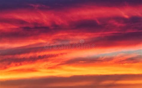 Fiery Clouds In Morning Sky During Sunrise Seen Through A Glass