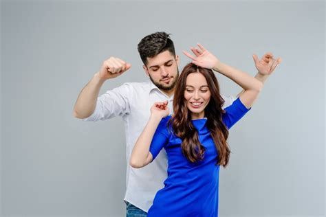 Premium Photo Man And Woman Dancing Together Isolated Over Grey Background
