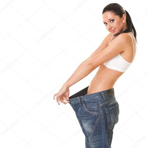 Pretty Woman Shows Her Weight Loss By Wearing An Old Jeans Isol Stock