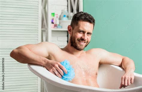 macho naked in bathtub sex and relaxation concept wash off foam with water carefully man wash