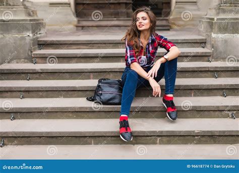 Portrait Of A Beautiful Young Woman Sitting On Stairs Outdoors Beautiful Young Woman Smiling
