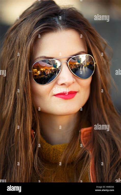 Outdoor Portrait Of Young Hispanic Woman With Curly Hair In Sunglasses