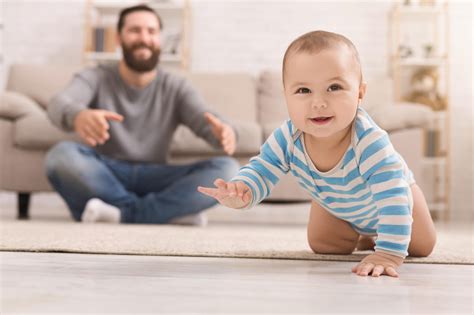 Adorable Baby Boy Crawling On Floor With Dad Property Management