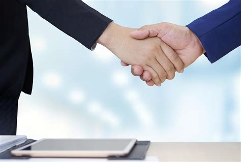 Close Up 2 Business People Shaking Hands During Meeting In Office Room