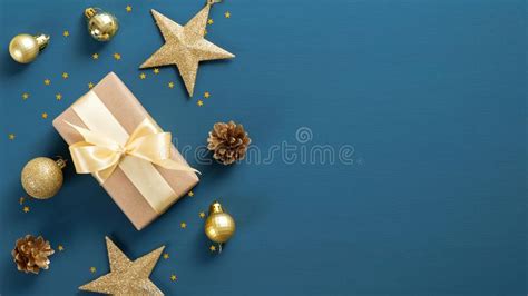 christmas blue background   border  gift box golden stars  balls confetti flat lay