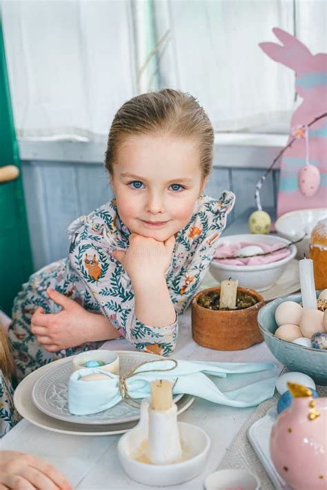 Girl At Table With Easter Decoration Celebration In Kitchentablescape