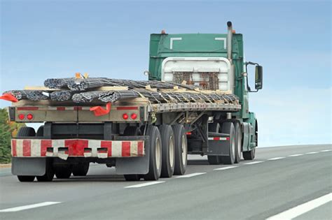 Semi Flatbed Truck Hauling Rebar To A Construction Site Stock Photo