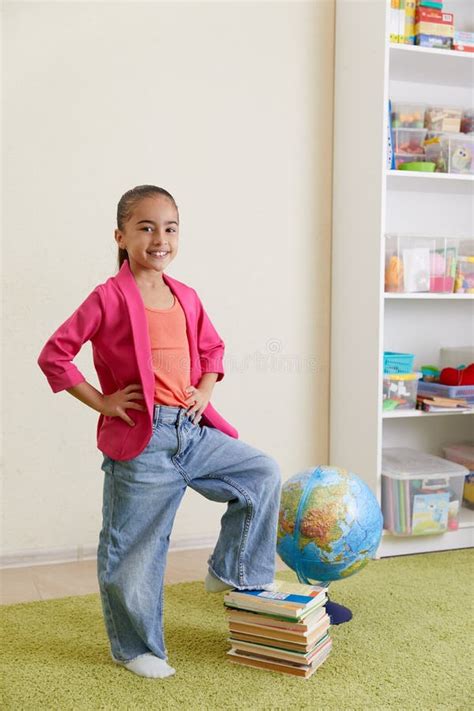 Portrait Of Cute Little Latin Schoolgirl In Classroom Happy Young