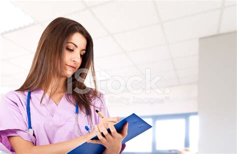 Young Nurse Reading A Clipboard Stock Photo Royalty Free Freeimages
