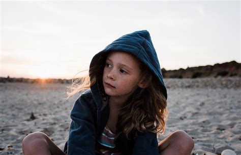 Portrait Of A Young Girl Sat At The Beach At Sunset Photograph By Cavan