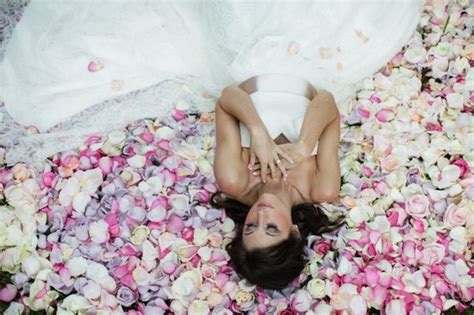 Bride Lays In A Bed Of Romantic Roses