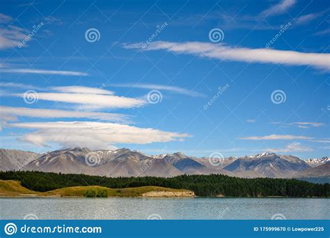 Mountains And Pine Trees On A Day With Beautiful Clouds And Blue Skies