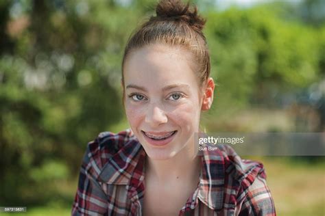 Portrait Of Teenage Girl With Dental Braces Looking At Camera Smiling
