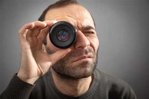 Premium Photo Man Looking Through Camera Lens