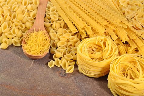 Assortment Of Uncooked Italian Pasta On A Wooden Background Stock Image