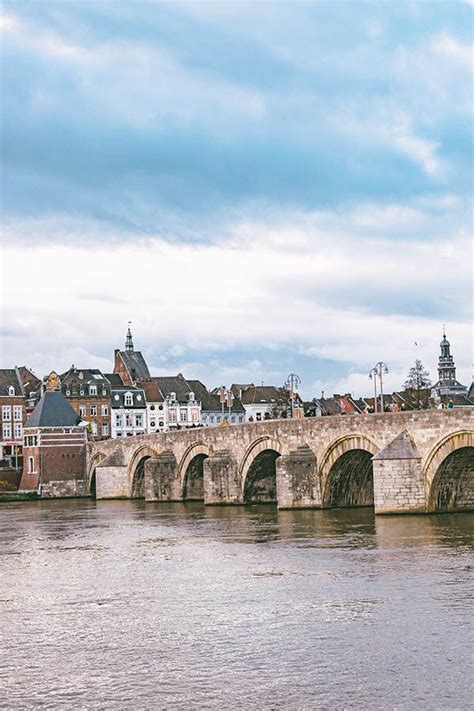 Beautiful View Of The Maas River With Bridge With Maastricht Historic