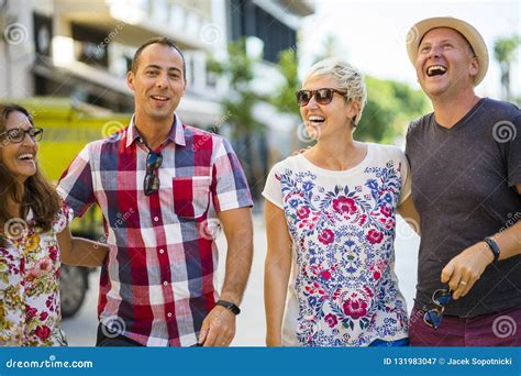 Cheerful Two Couples Having Fun in Front of Apartments Stock Image