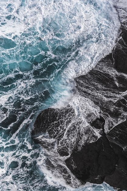 Free Photo Vertical Aerial Shot Of Sea Waves Hitting The Rocks
