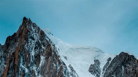 Download Wallpaper 2560x1440 Mountain Rock Cliff Peak Snow