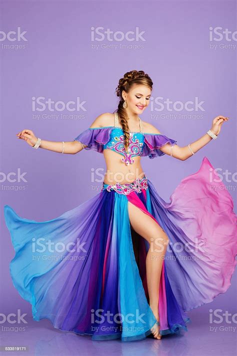 Beautiful Belly Dancer Wearing A Purple Costume Stock Photo Download