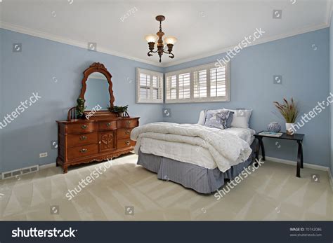 Master Bedroom In Suburban Home With Light Blue Walls Stock Photo