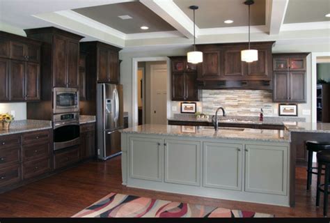 • gray kitchen cabinets are versatile. Dark brown kitchen cabinets, grey island contrast | Dark ...