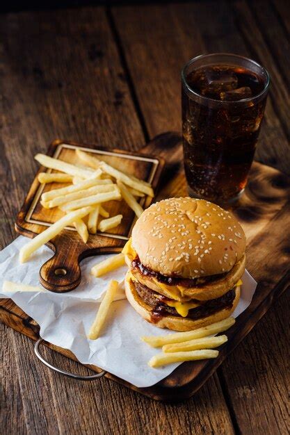 Premium Photo Burgers And French Fries On Wooden Table