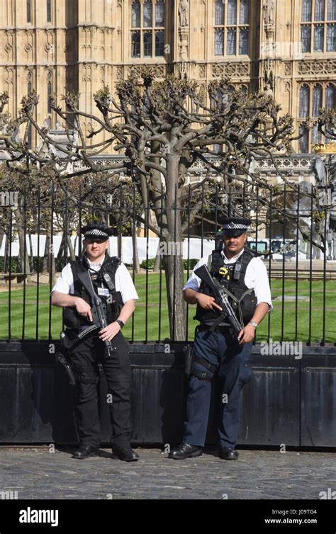 armed police guard the palace of westminster houses of parliament westminster london uk stock