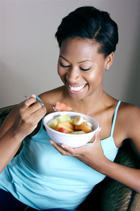 Woman Enjoying A Bowl Of Fresh Fruits Dano Milk Nigeria