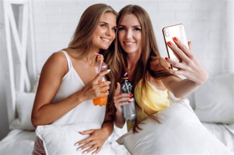 premium photo closeup of phone girls doing selfies and drinking
