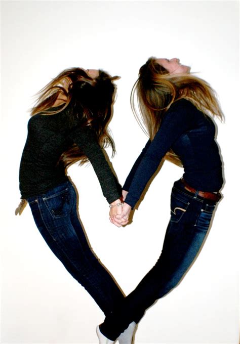 Two Women Holding Hands In The Shape Of A Heart