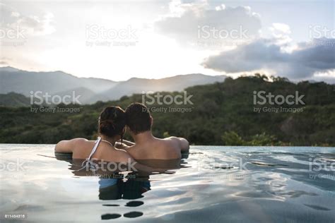 Romantic Couple Enjoying Their Holidays In The Swimming Pool Stock