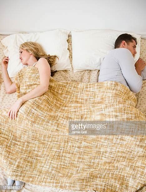 Sad Young Couple Bed Photos And Premium High Res Pictures Getty Images