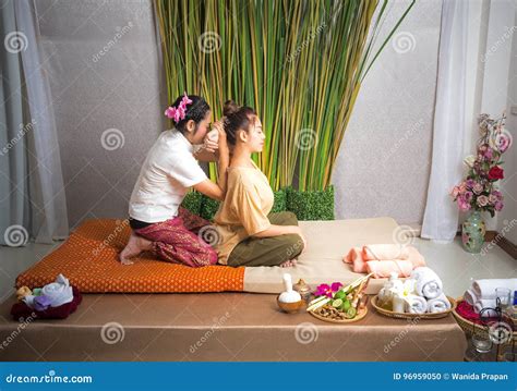 Thai Masseuse Doing Massage For Woman In Spa Salon Asian Beautiful Woman Getting Thai Herbal