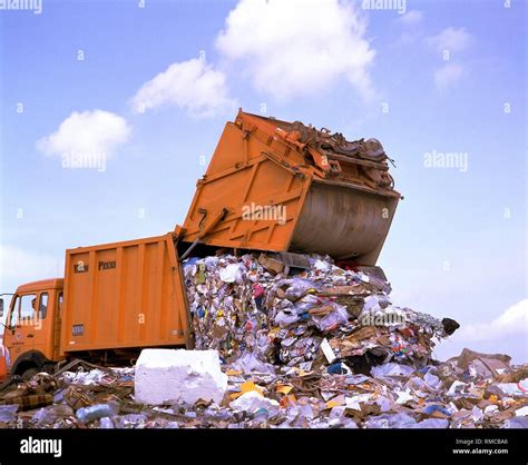 Garbage Truck Unloading Waste At A Garbage Dump In North Rhine