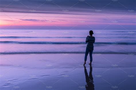 Woman Looking Out To Ocean At Sunset High Quality People Images
